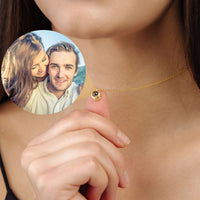 Thumbnail for Personalised Circle Necklace with a custom picture inside, showcasing a couple in a loving moment. Brand: Brother & Sisters.