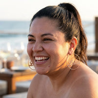 Thumbnail for Custom Name Hoop Earrings in Rose Gold worn outdoors, lifestyle shot | SKU: name-hoop-rose-gold-30-mm