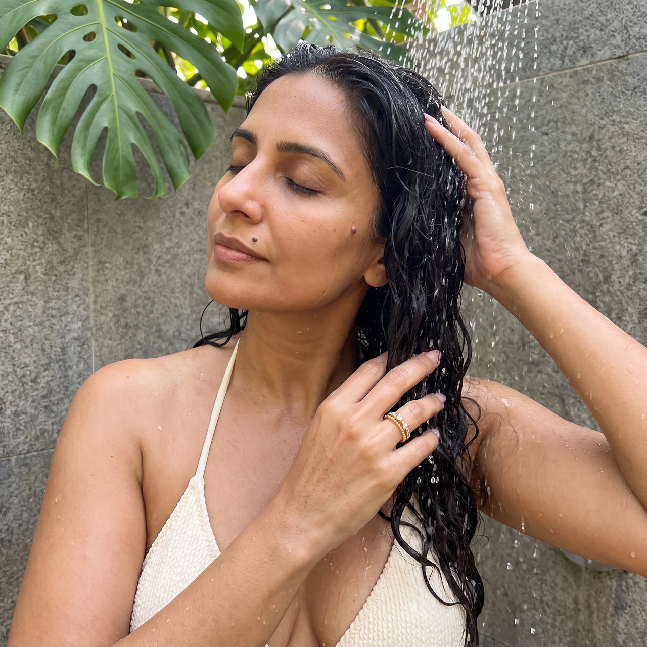 The Butterfly ring in gold worn in an outdoor shower | SKU: lepapillon