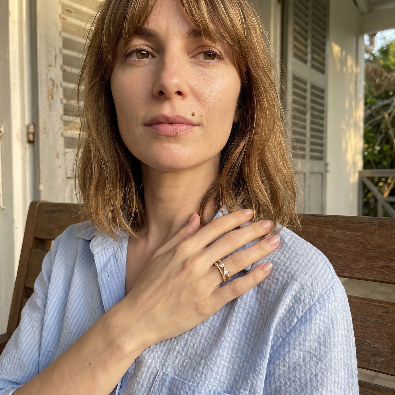Woman gently touching her Butterfly ring in gold | SKU: lepapillon