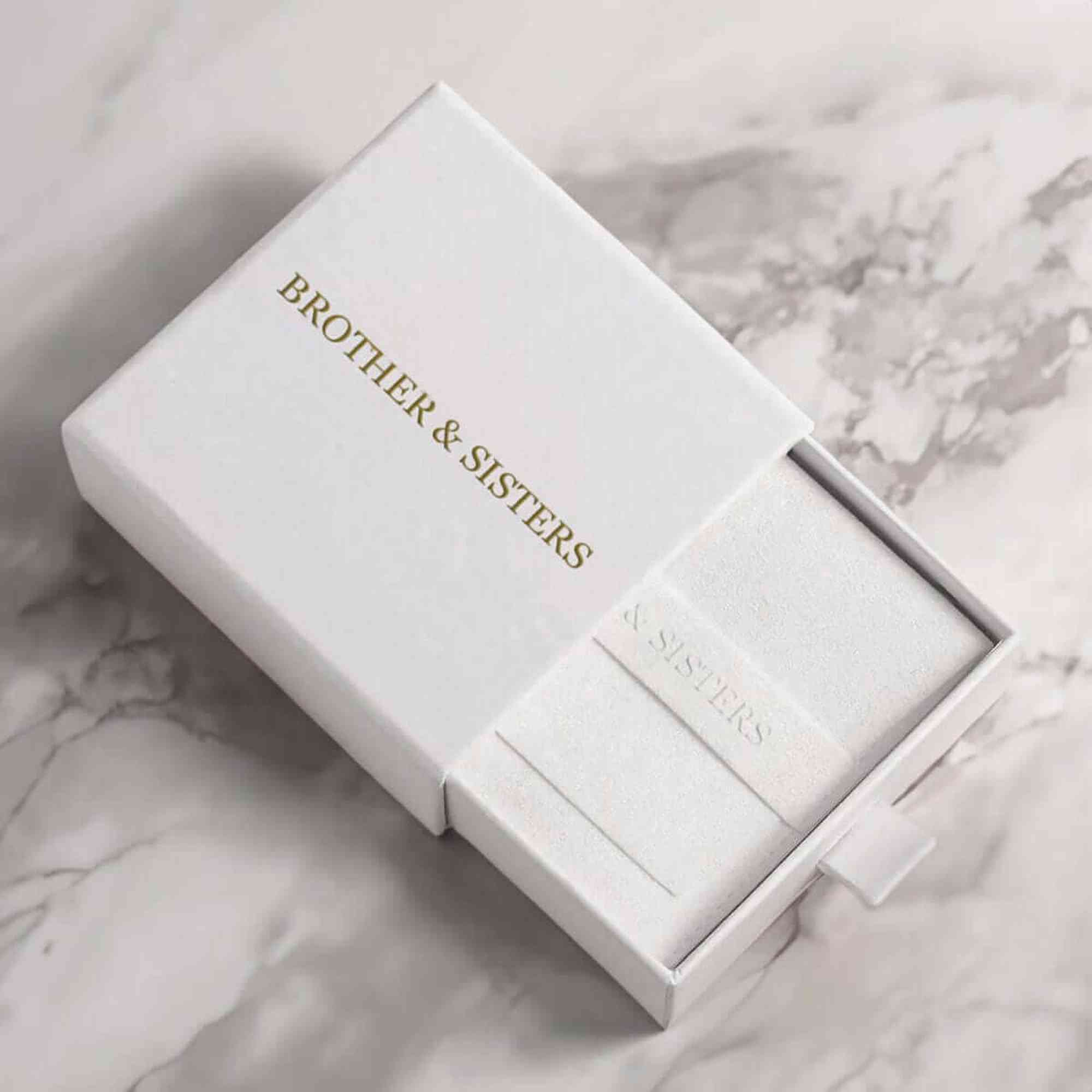 White jewelry box by Brother & Sisters for Sunflower Photo Necklace, elegant packaging for cherished keepsakes.