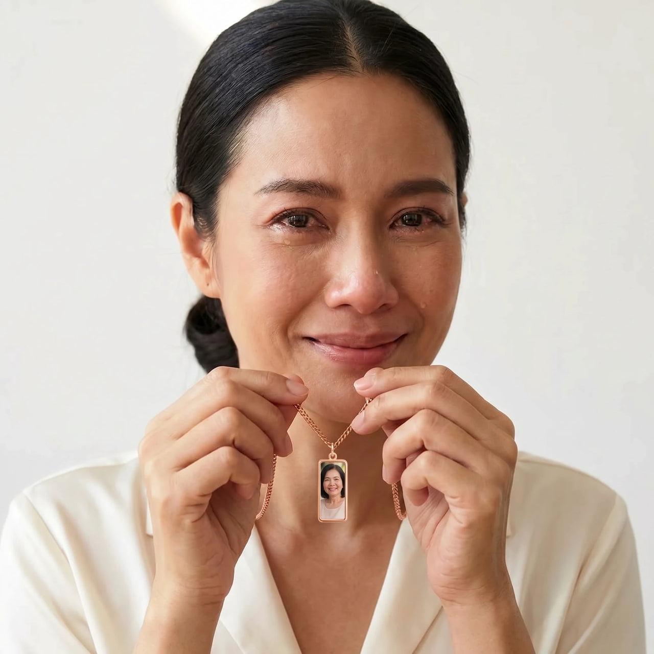 Woman moved as she looks at her late mother's photo in the rose gold bar necklace | SKU: TPH-BARN-ROSEGOLD
