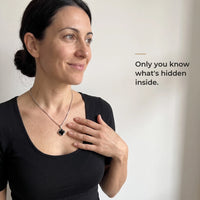Thumbnail for Woman in a black top touching the black clover pendant on its silver chain, only she knows the photo inside | SKU: TPH-CLVN-SILVER