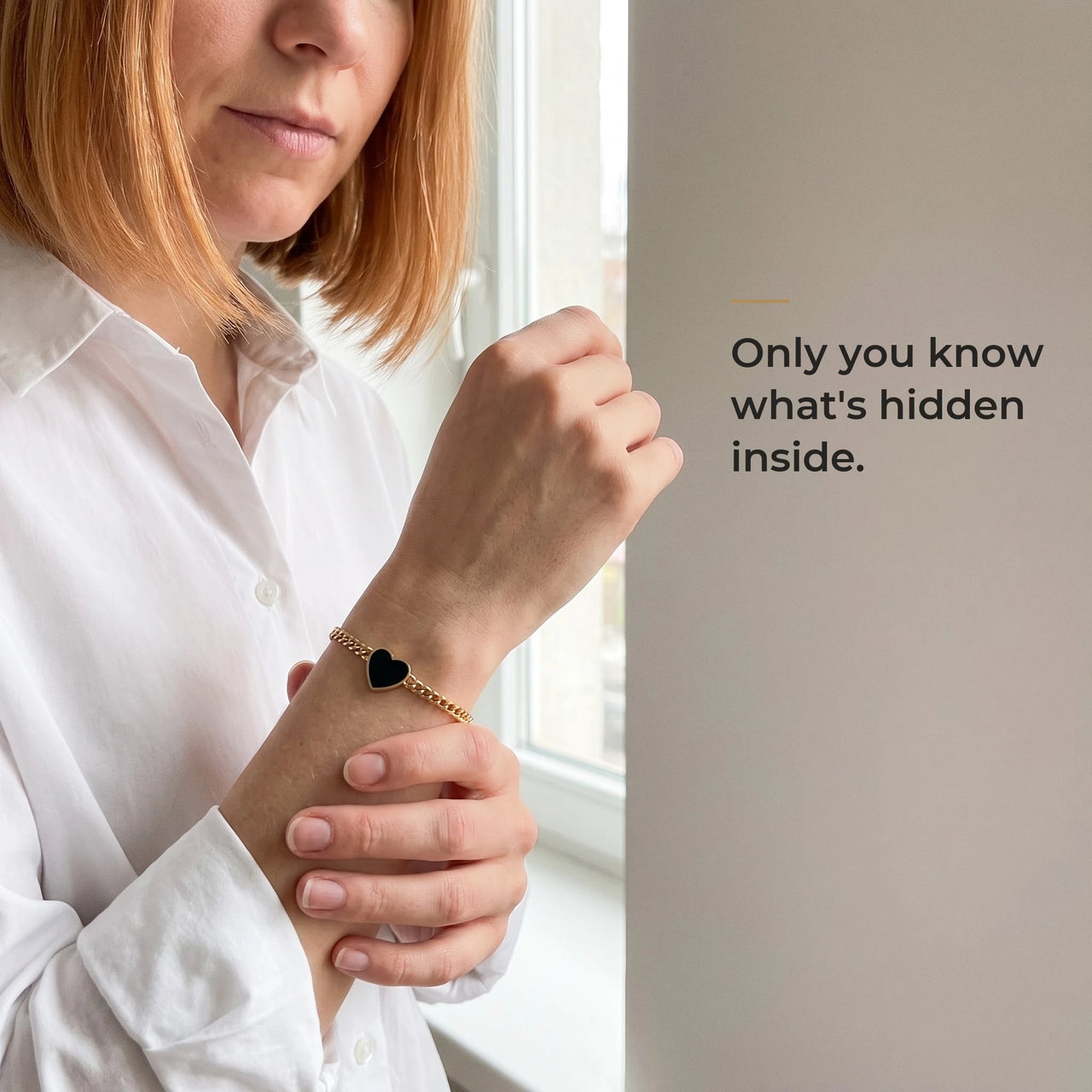 Woman wearing the gold bracelet with its black heart charm, only she knows the photo inside | SKU: TPH-HRTB-GOLD