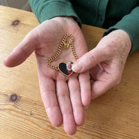 Thumbnail for Thumb warming the gold heart bracelet plate: the hidden photo appears under the thumb while the rest stays black | SKU: TPH-HRTB-GOLD