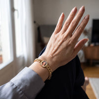 Thumbnail for A tear on her hand as she looks at her mother's photo in the gold round photo bracelet | SKU: TPH-RNDB-GOLD