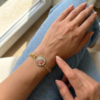Thumbnail for Looking down at the gold round photo bracelet on her wrist, showing its real small size | SKU: TPH-RNDB-GOLD